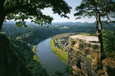 High angle view of river amidst trees against sky