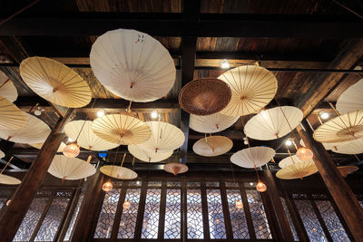 Low angle view of illuminated lanterns hanging on ceiling