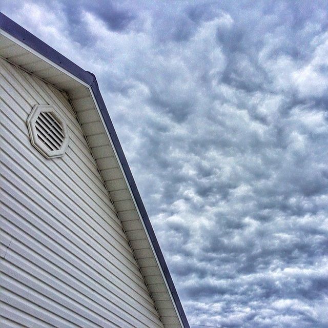 low angle view, sky, cloud - sky, architecture, built structure, cloudy, building exterior, cloud, building, modern, overcast, weather, outdoors, day, high section, no people, tall - high, pattern, city, tower