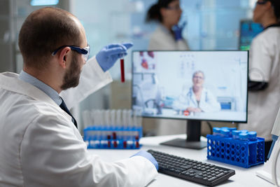 Doctor having discussion with colleague on video call