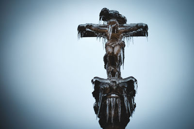 Low angle view of statue against sky