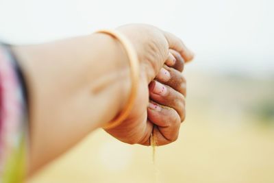 Woman 's hand holding sand