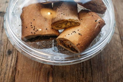 Close-up of sweet food served in glass bowl on wooden table