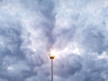 Low angle view of illuminated street light against sky