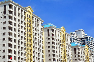 Low angle view of buildings against blue sky