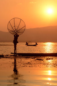 Silhouette of people at sunset