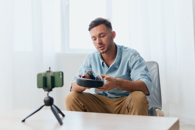 Young man vlogging at home