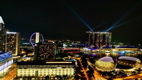 Illuminated buildings against sky in city at night