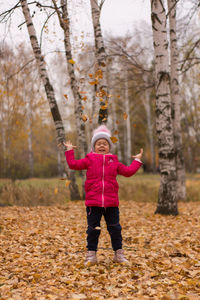 Full length of woman with umbrella during autumn