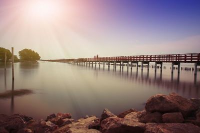 Scenic view of river against sky during sunset