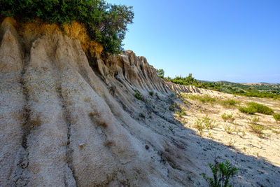 Scenic view of rocky mountains against clear blue sky