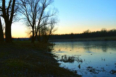 Scenic view of lake against sky during sunset