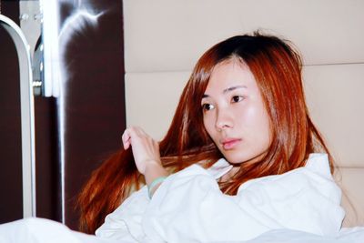 Close-up of girl sitting at home