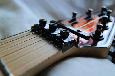 High angle view of guitar on sofa