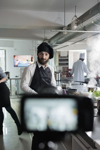 Portrait of chef standing in kitchen