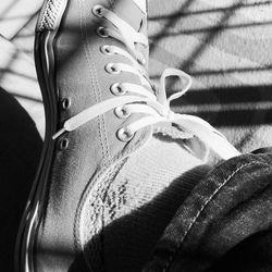 Low section of woman wearing canvas shoes