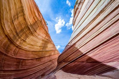 Scenic view of rocky mountains against sky on sunny day at coyote buttes