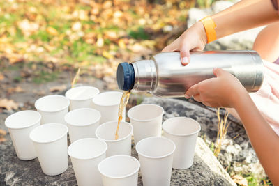 Cropped hand of woman drinking water