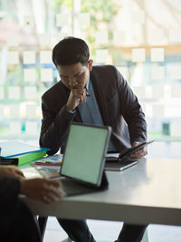 Thoughtful businessman brainstorming in office