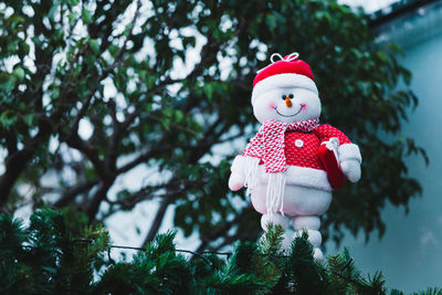 Snowman hanging from tree