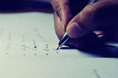 Close-up of human hand holding paper