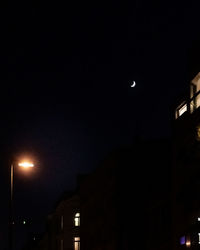 Low angle view of illuminated street light against sky at night