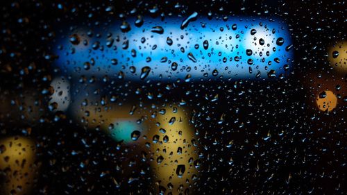 Full frame shot of raindrops on glass window