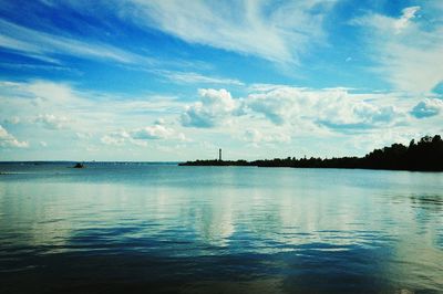 View of calm sea against cloudy sky