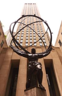 Low angle view of statue against building