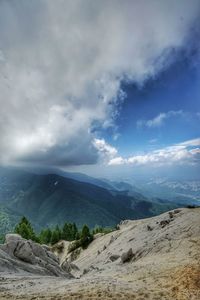 Scenic view of mountains against cloudy sky