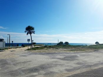 Scenic view of beach against blue sky