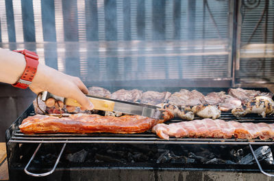 Man preparing food on barbecue grill