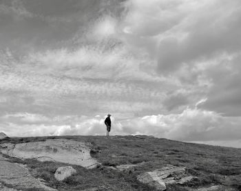 Man standing on field against sky