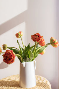 Close-up of flowers in vase on table.