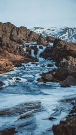 Scenic view of glaciers melting on mountains against clear sky