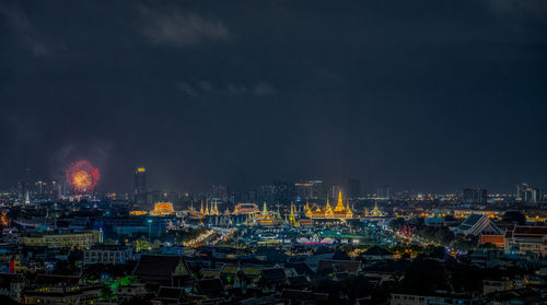 High angle view of illuminated buildings against sky at night