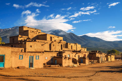 Buildings in city against cloudy sky