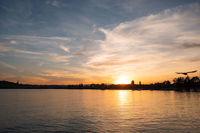 Scenic view of lake against sky during sunset