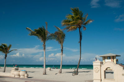 Scenic view of beach against blue sky