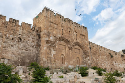 Low angle view of old ruins against sky