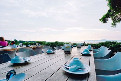 Boats moored in water against sky