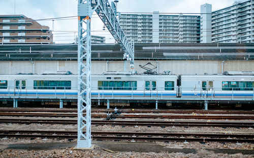 Railroad tracks amidst buildings in city