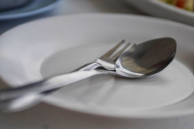 Close-up of eating utensils in plate on table