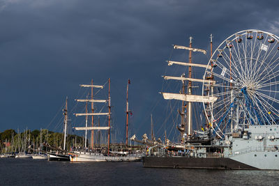 Ferris wheel in sea against sky