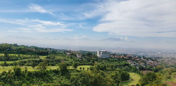 High angle view of trees and buildings against sky