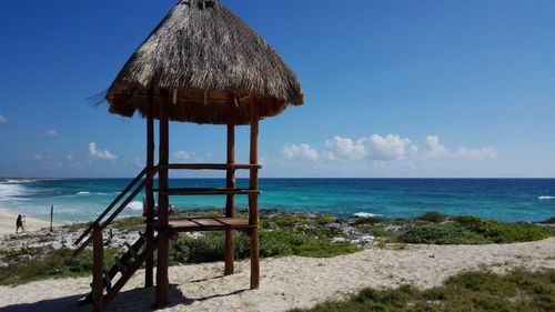 Lifeguard hut on beach against sky