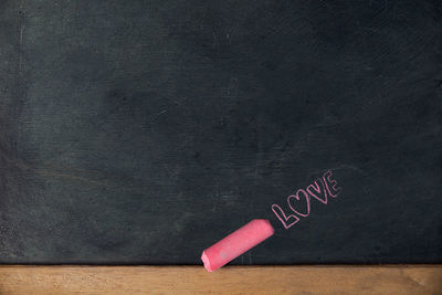 Close-up of love text on blackboard