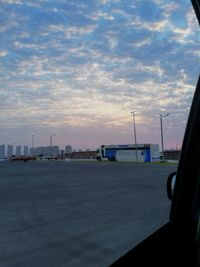 View of airport runway against sky during sunset