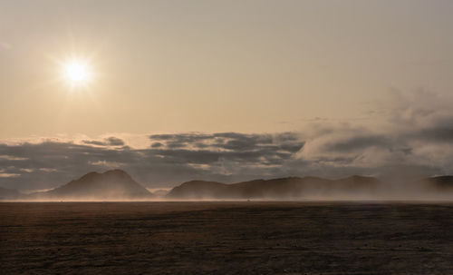 Scenic view of desert against sky during sunset