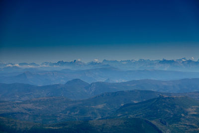 Scenic view of mountains against clear blue sky